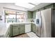 Bright kitchen features tile countertops, stainless refrigerator, and a garden window overlooking the patio at 2810 S Emerson --, Mesa, AZ 85210