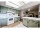 Bright kitchen features tile countertops, garden window, and view into dining room at 2810 S Emerson --, Mesa, AZ 85210