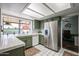Bright kitchen features tile countertops, stainless refrigerator, and a garden window overlooking the patio at 2810 S Emerson --, Mesa, AZ 85210