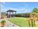 The backyard offers a pergola with a hot tub and a built-in outdoor kitchen area at 29081 N Cactus Cir, San Tan Valley, AZ 85143