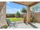 Relaxing covered patio overlooks a nicely landscaped backyard with a grassy area and privacy wall at 29081 N Cactus Cir, San Tan Valley, AZ 85143