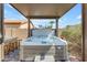 Inviting covered hot tub area with brick-paved patio and bar seating, perfect for relaxation and entertaining at 29081 N Cactus Cir, San Tan Valley, AZ 85143