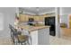 Bright, inviting kitchen with breakfast bar, light wood cabinetry and modern appliances at 29081 N Cactus Cir, San Tan Valley, AZ 85143