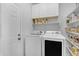 Convenient laundry room with built-in shelving and white washer/dryer units at 29081 N Cactus Cir, San Tan Valley, AZ 85143