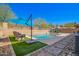 Stunning backyard pool featuring an umbrella, seating, and meticulously maintained landscaping for outdoor enjoyment at 2926 W Thorn Tree Dr, Phoenix, AZ 85085