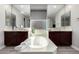 Bright bathroom featuring a soaking tub, dual sinks, and contemporary mirrors and lighting at 2926 W Thorn Tree Dr, Phoenix, AZ 85085
