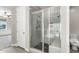 Bathroom with a glass-enclosed shower, gray subway tile, and view of the toilet, sink, and commode at 2926 W Thorn Tree Dr, Phoenix, AZ 85085