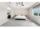 Bright and airy bedroom with plush carpet, ceiling fan, and a large window for natural light at 2926 W Thorn Tree Dr, Phoenix, AZ 85085