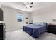 Comfortable bedroom with a ceiling fan, large window, and a dresser with a mirror at 2926 W Thorn Tree Dr, Phoenix, AZ 85085