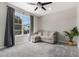 Bright bedroom featuring a large window, neutral walls, and soft carpeting at 2926 W Thorn Tree Dr, Phoenix, AZ 85085