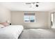 Inviting bedroom featuring neutral walls, plush carpeting, a ceiling fan, and ample natural light from the window at 2926 W Thorn Tree Dr, Phoenix, AZ 85085