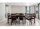 Open-concept dining room with tiled floors and a large wooden dining table with seating for eight at 2926 W Thorn Tree Dr, Phoenix, AZ 85085