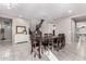 Open dining room with tile flooring, a large dining table, and staircase access at 2926 W Thorn Tree Dr, Phoenix, AZ 85085