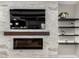 Modern fireplace with stone accent wall, a mounted TV, and floating shelves at 2926 W Thorn Tree Dr, Phoenix, AZ 85085