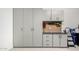 Well-organized garage with cabinets, drawers, workbench, and pegboard wall organizer at 2926 W Thorn Tree Dr, Phoenix, AZ 85085