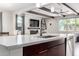 Bright kitchen with stainless steel appliances, dark wood cabinets and a fireplace at 2926 W Thorn Tree Dr, Phoenix, AZ 85085