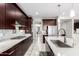 Well-equipped kitchen with stainless steel appliances, a gas cooktop, and ample counter space at 2926 W Thorn Tree Dr, Phoenix, AZ 85085