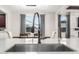 Close up of kitchen sink with view to dining area and fireplace at 2926 W Thorn Tree Dr, Phoenix, AZ 85085