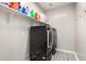 Modern laundry room featuring stacked washer and dryer with shelving above at 2926 W Thorn Tree Dr, Phoenix, AZ 85085