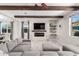 Inviting living room with a gray sectional, decorative beams, and a cozy fireplace at 2926 W Thorn Tree Dr, Phoenix, AZ 85085