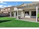 The spacious backyard includes a covered patio with a pergola and an artificial grass lawn for outdoor enjoyment at 29374 N 125Th Dr, Peoria, AZ 85383