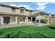 The backyard is equipped with artificial turf, a covered patio, and a pergola creating a comfortable outdoor living space at 29374 N 125Th Dr, Peoria, AZ 85383