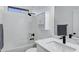 Clean, bright bathroom with marble countertop, modern fixtures, and shower-tub combination at 29374 N 125Th Dr, Peoria, AZ 85383