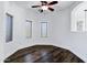 Cozy bedroom with dark wood-style flooring, recessed lighting, ceiling fan and multiple windows at 29374 N 125Th Dr, Peoria, AZ 85383