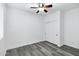 Bright bedroom featuring light gray laminate flooring, a ceiling fan, and a sliding door closet at 29374 N 125Th Dr, Peoria, AZ 85383