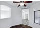 Cozy bedroom with dark wood-style flooring, recessed lighting, arched window, and an open archway at 29374 N 125Th Dr, Peoria, AZ 85383