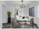 Cozy dining room with stylish chandelier, modern artwork, and comfortable seating for four at 29374 N 125Th Dr, Peoria, AZ 85383