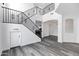 Open-concept foyer showcasing elegant staircase, archway, and modern flooring throughout at 29374 N 125Th Dr, Peoria, AZ 85383