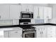 Close up of a kitchen with stainless steel oven and microwave, surrounded by white cabinets at 29374 N 125Th Dr, Peoria, AZ 85383