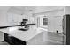 Bright, spacious kitchen with white cabinetry, stainless steel appliances, and black marble countertops at 29374 N 125Th Dr, Peoria, AZ 85383