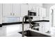 Modern kitchen with a stainless steel faucet, stainless steel appliances, and white cabinets at 29374 N 125Th Dr, Peoria, AZ 85383