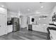 Spacious kitchen with stainless steel appliances, white cabinetry, and an open concept design at 29374 N 125Th Dr, Peoria, AZ 85383