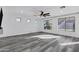 Large living room with luxury flooring, neutral paint, large windows and ceiling fan at 29374 N 125Th Dr, Peoria, AZ 85383