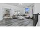 Bright, inviting living room with stylish furniture, gray floors, and a view into an adjacent sitting area at 29374 N 125Th Dr, Peoria, AZ 85383
