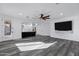 Open-concept living room showcasing luxury vinyl floors and seamless flow to the kitchen at 29374 N 125Th Dr, Peoria, AZ 85383