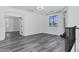 Upstairs bonus living room with sleek wood-style flooring, natural light, and an open archway to another room at 29374 N 125Th Dr, Peoria, AZ 85383