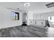 Bright loft featuring wood-style flooring, large window, and open archway offering flexible living space at 29374 N 125Th Dr, Peoria, AZ 85383
