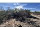 Desert property with worn structure amid arid vegetation and clear blue sky at 3200 S Mesa Rd, Winkelman, AZ 85192