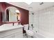 Modern bathroom with a stylish vanity, sleek mirror, and a glass-enclosed shower-tub combination at 3401 N 37Th St # 12, Phoenix, AZ 85018