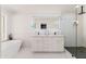 Bright bathroom featuring a modern vanity, soaking tub, and sleek glass-enclosed shower with contemporary finishes at 3401 N 37Th St # 12, Phoenix, AZ 85018