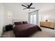 Bedroom featuring a comfortable bed, modern ceiling fan, and a sliding door to a private balcony at 3401 N 37Th St # 12, Phoenix, AZ 85018