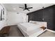 Modern bedroom featuring a king-size bed, dark accent wall, and ensuite bathroom access at 3401 N 37Th St # 12, Phoenix, AZ 85018