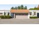 Charming exterior view of the home with a tan garage door and well-maintained landscaping at 3401 N 37Th St # 12, Phoenix, AZ 85018