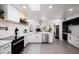 Bright kitchen with stainless steel appliances, white cabinets, and open layout to the living room at 3401 N 37Th St # 12, Phoenix, AZ 85018