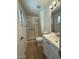 Bathroom with a glass enclosed shower and white vanity at 3515 E Winchcomb Dr, Phoenix, AZ 85032