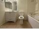 Bright bathroom featuring a white vanity, toilet, and a jetted bathtub at 3515 E Winchcomb Dr, Phoenix, AZ 85032